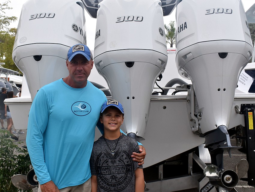 Owner and operator of Tiki Taxi Eric Grossarth checks out the show with his son Wyatt.