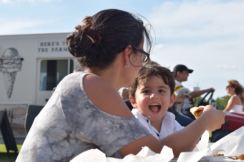 Daniela DaSilva fed her 3-year-old son Milad some tasty snacks offered at the farmer's market.