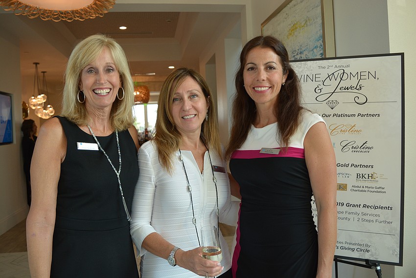 Giving Circle members Tig Winsler, Carmela Quagliato and Andrew Rutsky greet guests.