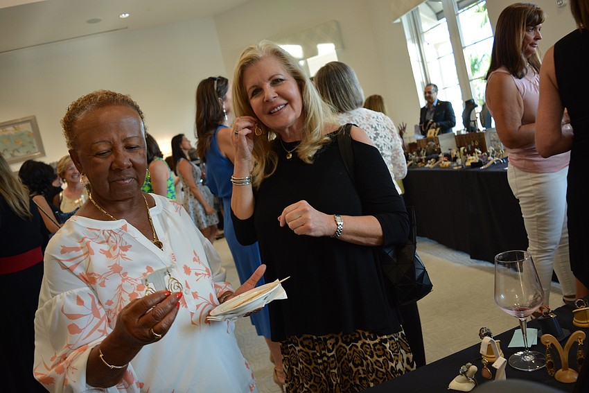 Rosedale Golf and Country Club resident Naomi Margolick and Palm Aire resident Beth Wallace try on jewelry from Pianegonda and Bellarri.