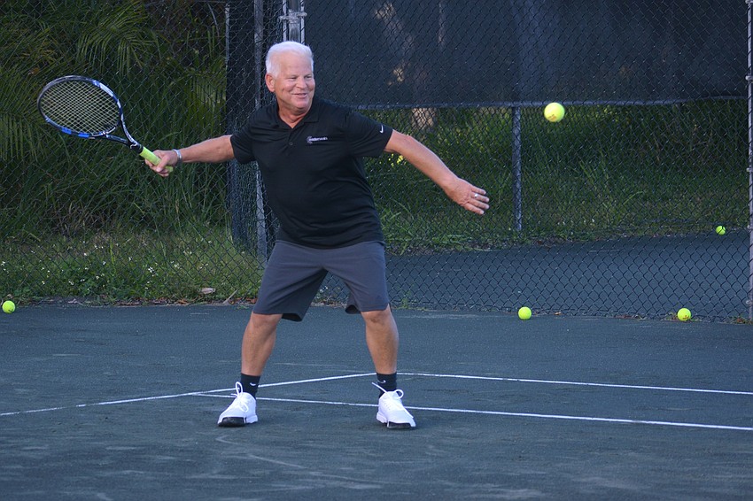 Don Herndon lets his racket fly.