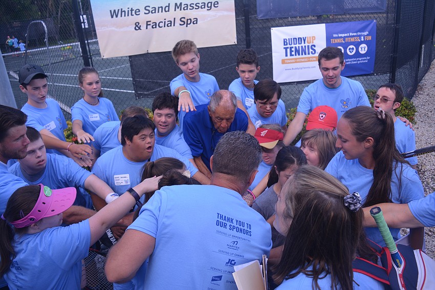 Nick Bollettieri breaks down the Buddy Up Tennis participants' huddle with a rousing cheer.