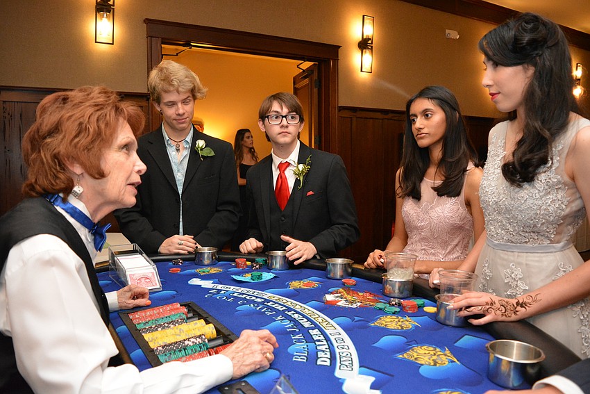 Dealer Carolyn Branco is impressed with the blackjack performance of Leeson Foullon, Kelland Timothy, Arya Bulusu and Nina Dinh.