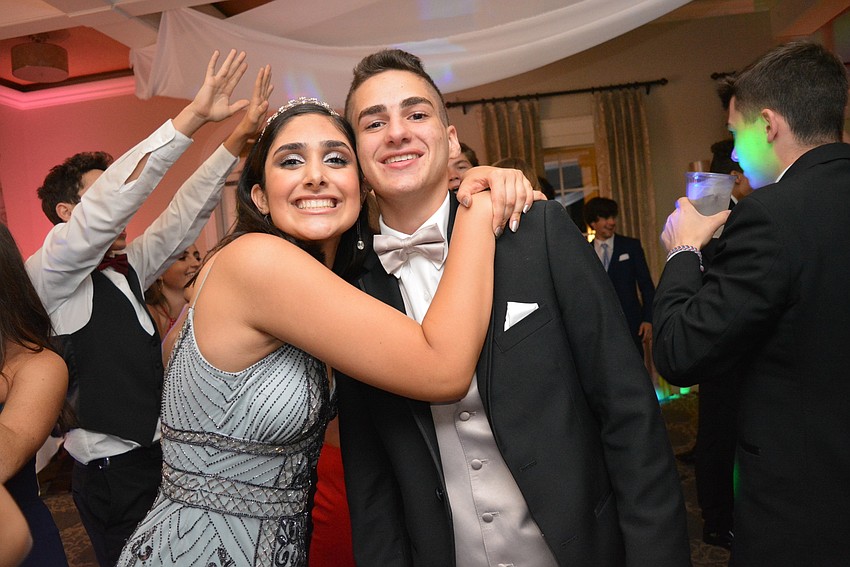 Senior Sofia Delgado pauses her dancing to hug friend John Colosimo.