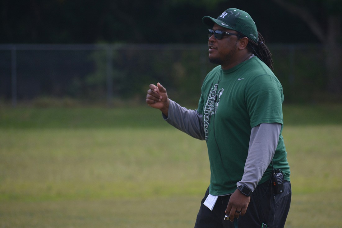 New Lakewood Ranch coach Rashad West gives instructions to his team during spring practice. West said the Mustangs are using "training wheels" in practice for now.