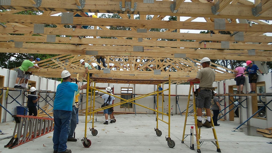 Habitat for Humanity of Manatee County volunteers secure tresses for a new home under construction. Volunteers work in a variety of roles, whether building homes or helping with office work. Courtesy photo.