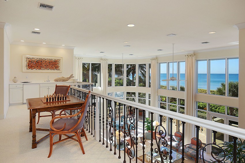 A sitting area overlooks the downstairs living areas.