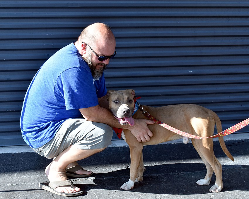 Joe Larsen plays with pit bull Hoover.