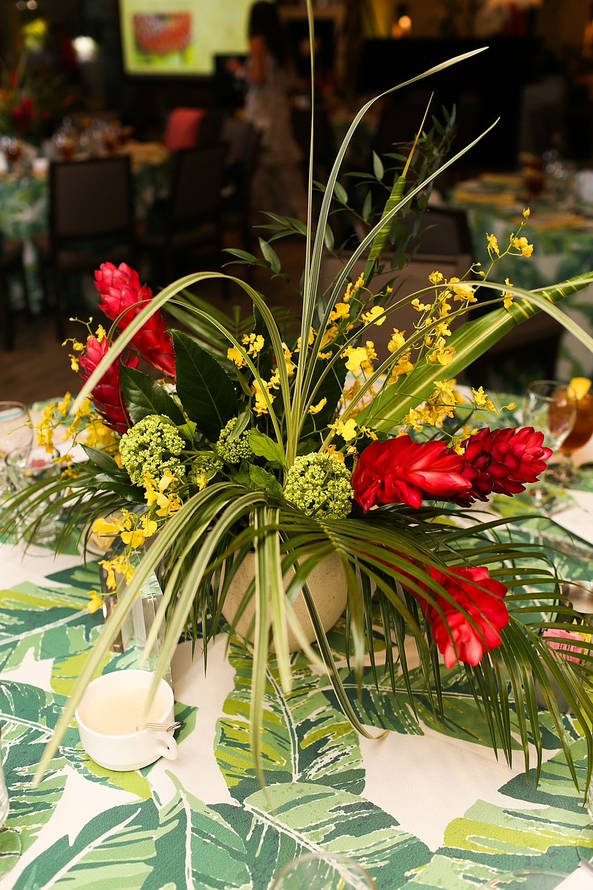 The centerpieces featured elegant tropical florals.