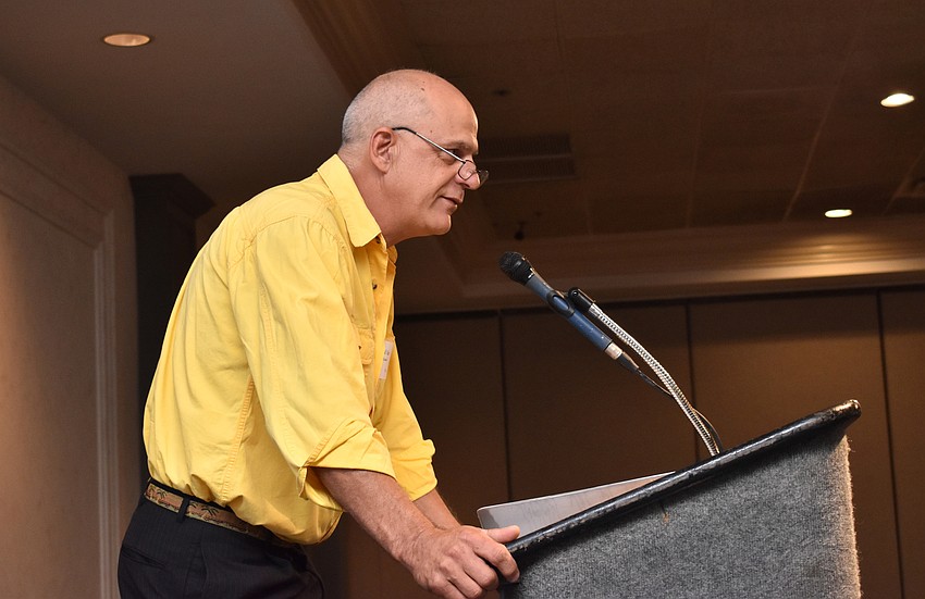 Phil Yoder, who served in Ecuador with the Peace Corps, welcomes guests to the luncheon.