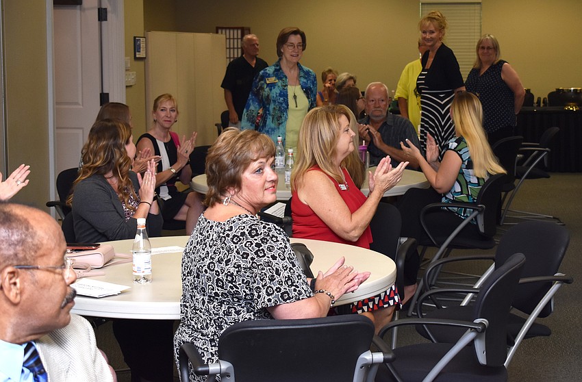 Eventgoers applaud the board members of Florida Winefest and Auction.