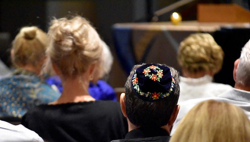 Guests take a moment to reflect on the lives lost.