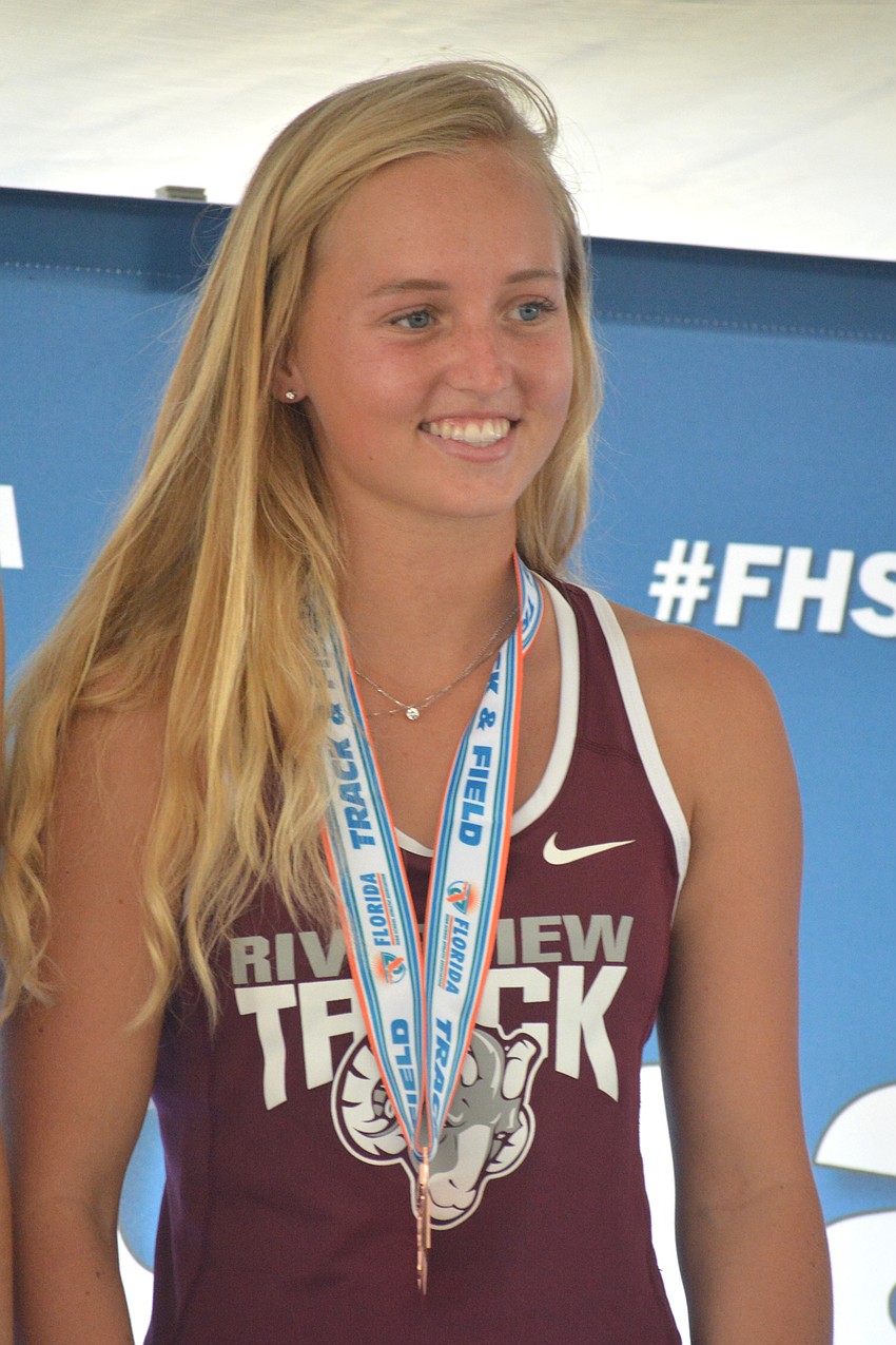 Riverview High senior Lauryn Dougherty smiles after tying for bronze in the 4A girls pole vault.