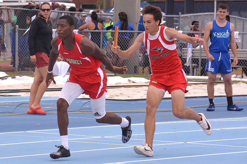 Cardinal Mooney junior Meko Mayes takes the handoff from junior Connor Powers in the 1A 4x100 relay. The Cougars finished 17th (45.07).