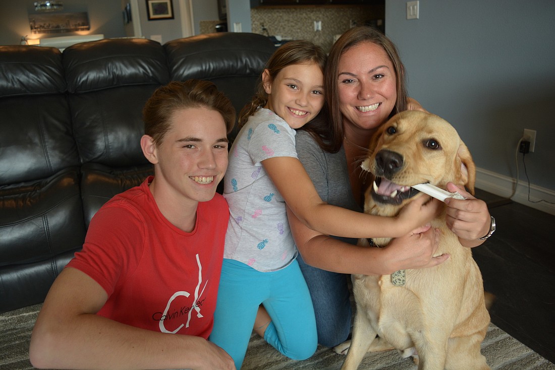Conner Reese and Kiley and Rachel Nowaczyk love that their dog, Stashu, is calm and well trained.