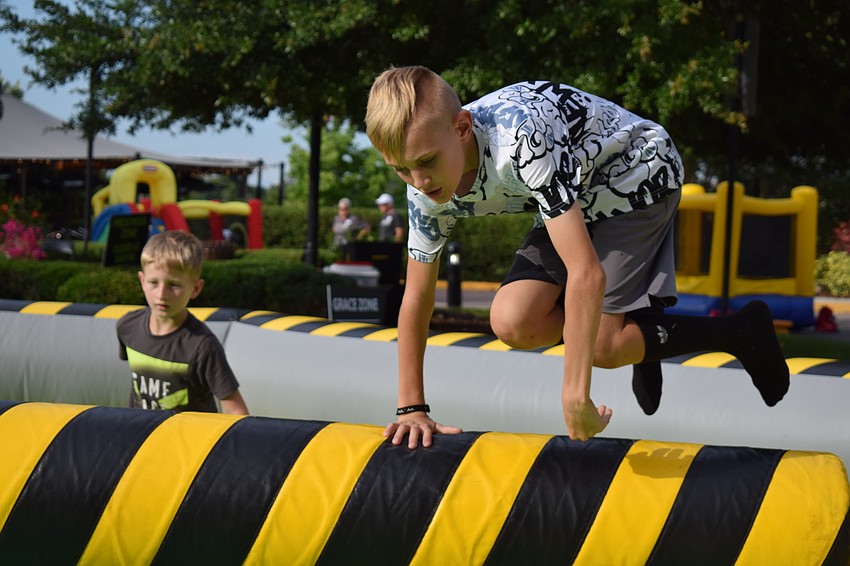 When faced with the threat of the mechanical arm hurtling toward him, Sarasota's Wyatt Donato hurdled it.