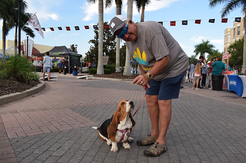 Larry Keene, of Parrish, uses a treat to catch the attention of his dog, Lacy.