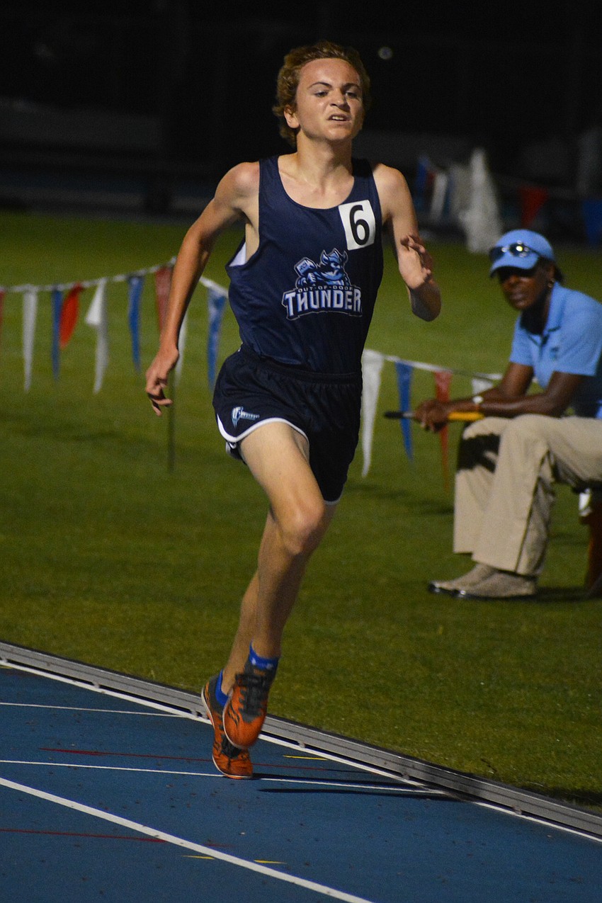 The Out-of-Door Academy freshman Tristan McWilliam sprints through the finish of the 1A boys 3200-meter race. He finished 10th.