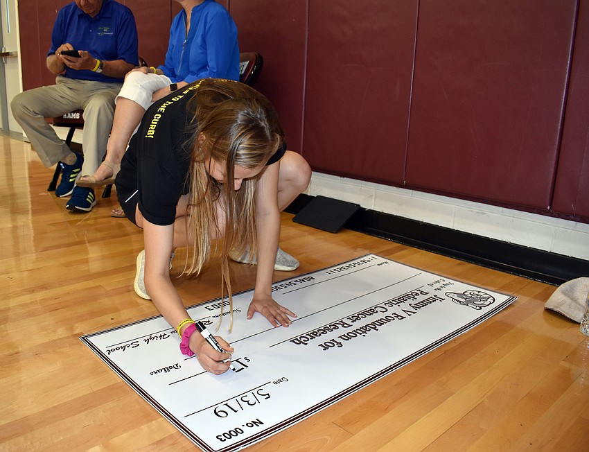 Amy Dunn writes out the $1,711 check.
