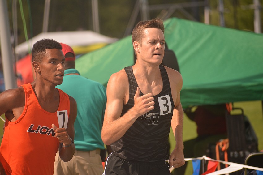 Lakewood Ranch senior Johnny Reid (right) pounds the pavement next to eventual winner Angel Vicioso of Oviedo during the 4A boys 1600-meter race. Reid would finish second.
