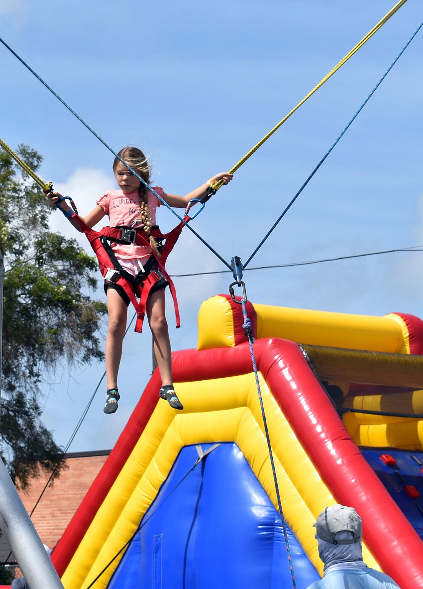Olivia Hamilton tries to do a flip on a trampoline.