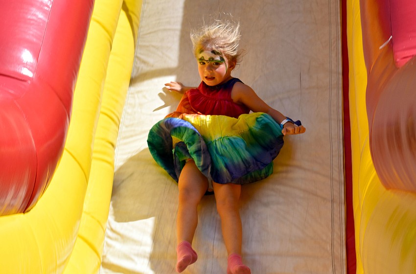 Maisie Pacinelli slides down an inflatable course.