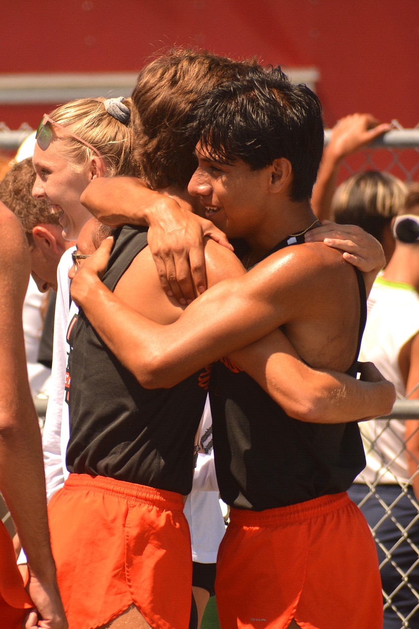 Ben Hartvigsen and Alan Galicia-Romero hug after the Sailors' 4x800 relay.