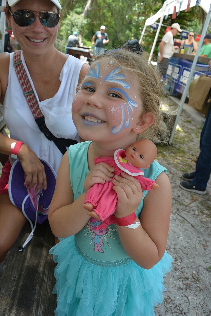 GreyHawk Landing 5-year-old Claire Alexander loved the new doll she got at a vendor booth. Her parents, Trasi and Matt, enjoyed the music.