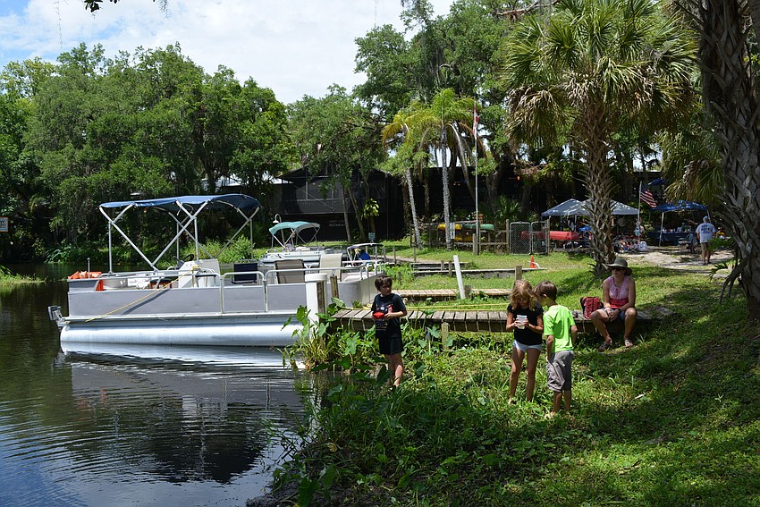 Guests enjoy being beside the river as they listen to music.