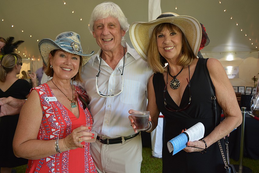 SMART volunteer and Lakewood Ranch resident Candi Russell catches up with friends Tom and Sherry Wilson, of Sabal Harbour.