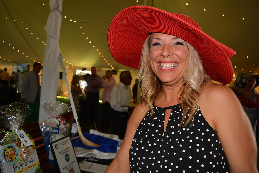 Rio Mar resident and Sarasota Military Academy Chief Development Office CJ Bannister hunts through silent auction items.