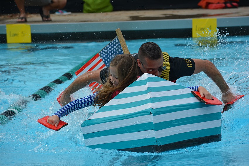 Gullett student Samantha Strohbach races down the lane with her dad, Arthur Strohbach, providing power in the back.