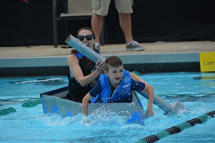 Kristina Engelsberg is having a blast as her son, Gullett student Max Engelsberg, paddles with his hands.