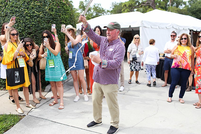 Michael Klauber opens the first bottle of Champagne.