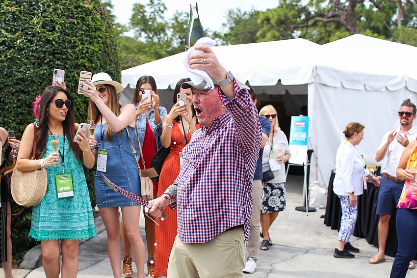 Michael Klauber opens the first bottle of Champagne.