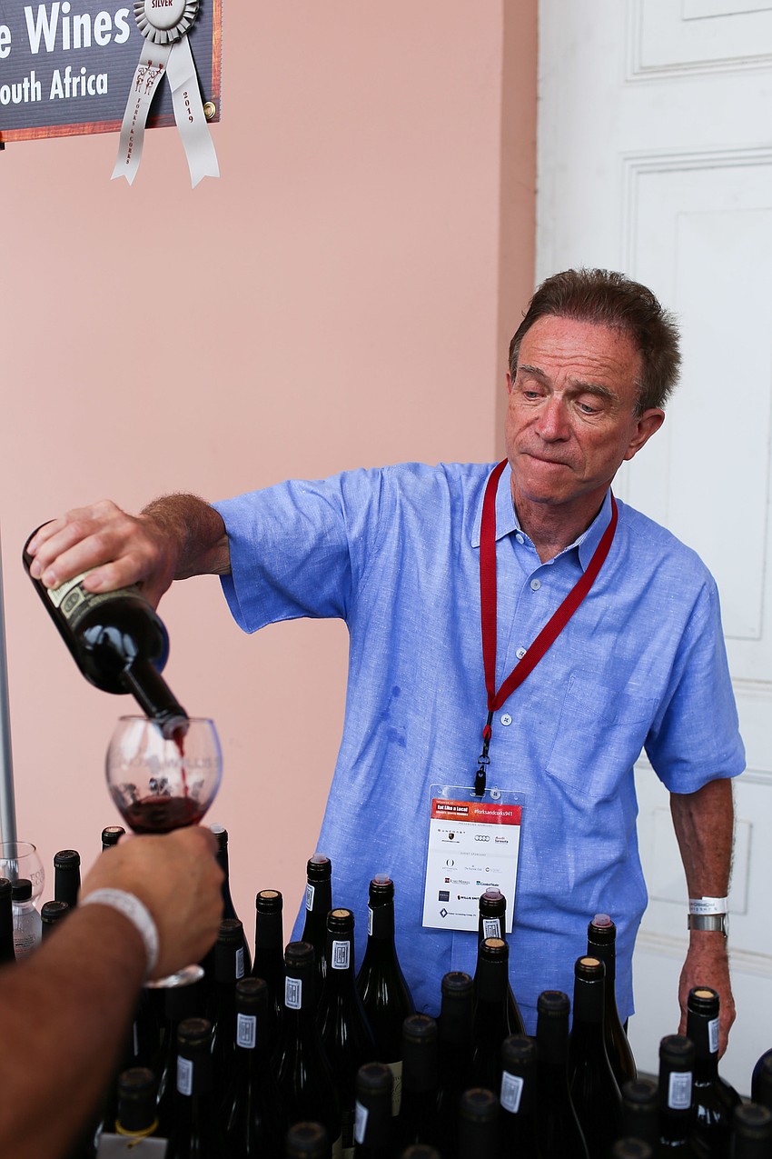 Post House Wines' Terry Seitz pours a glass of wine.
