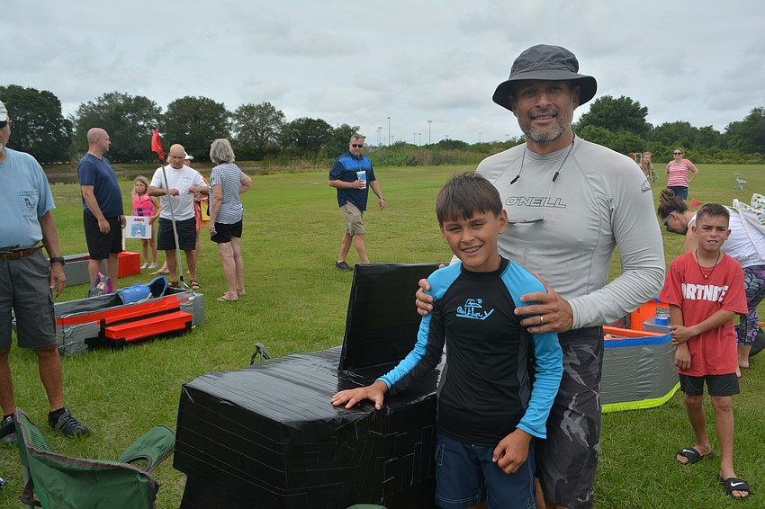 McNeal student Lucas Diaz and his dad, Julio Diaz, show off their boat before the race, but unfortunately ...