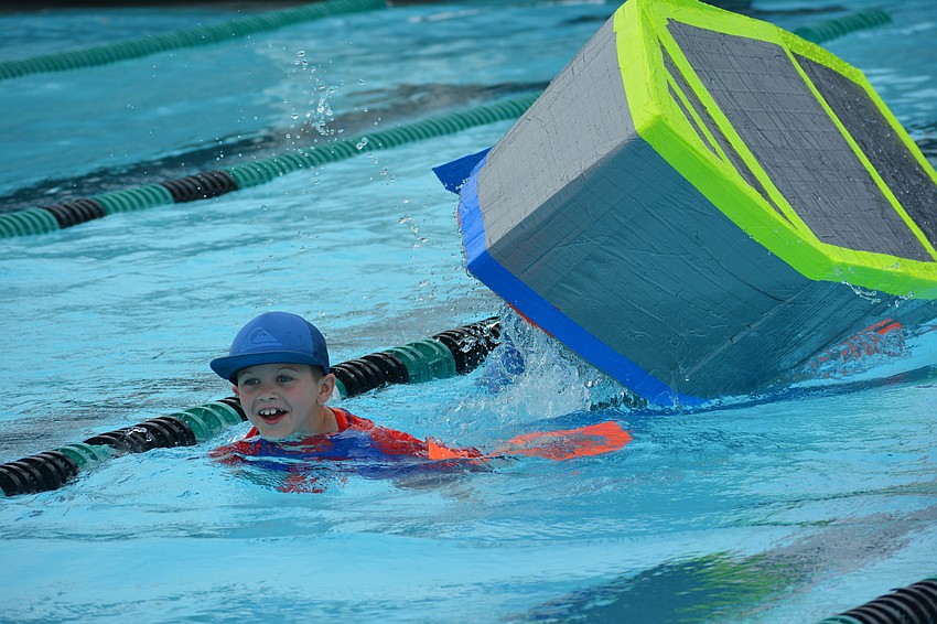Tara third-grader Drake Trombetta is all smiles as he swims away from his capsized boat.