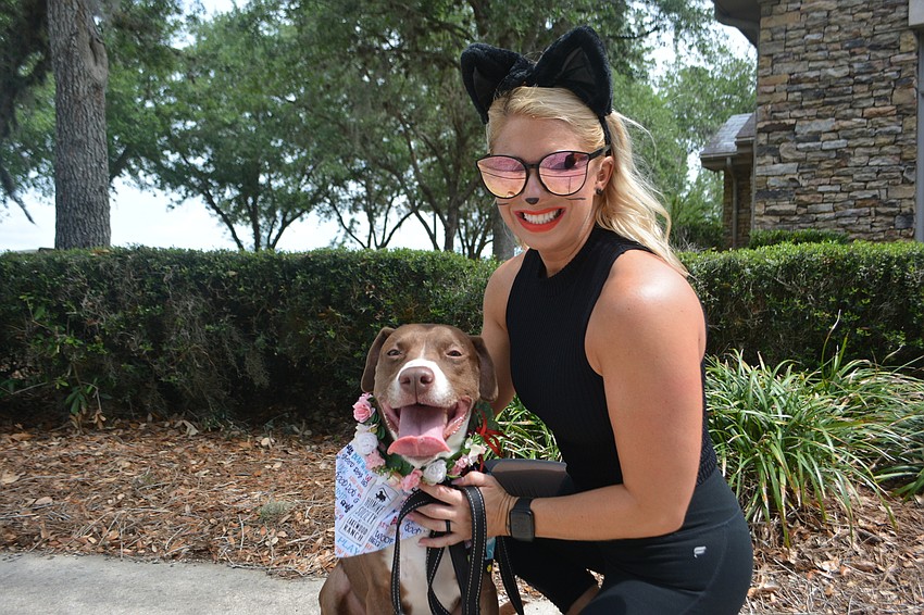 Kelly Lassiter, a volunteer for the Humane Society at Lakewood Ranch, dresses as a black cat and hangs with Lola, a Humane Society alum.