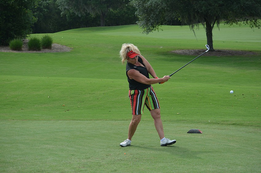 Peggy Kronus, the community business development manager for Willis Smith, powers a shot off the tee.