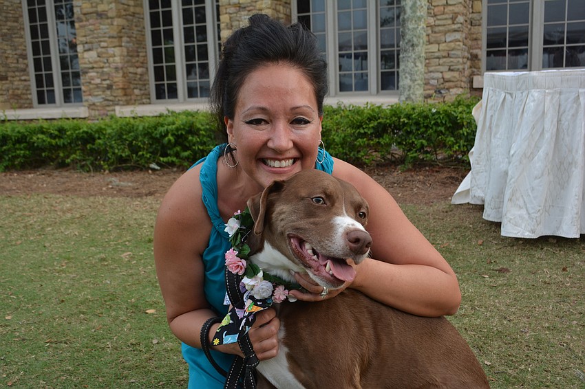 Rebekah Boudrie hugs Lola, a Lab-pitt bull mix, during a walk down the red carpet. Lola is a Humane Society at Lakewood Ranch alumna.