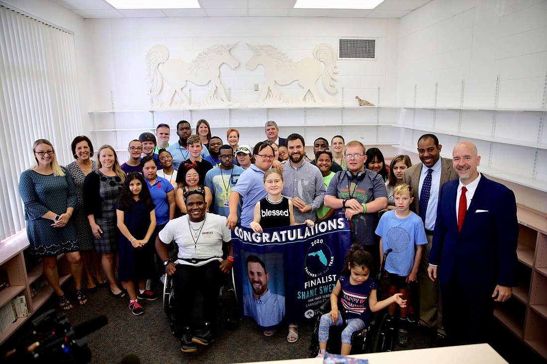 Shane Swezey surrounded by students and staff at Oak Park School along with school district administrators and Florida Department of Education leadership. Photo courtesy of the Florida Department of Education.