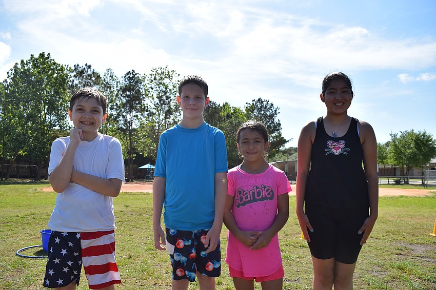 Nate Burg, Dylan Cramer, Juliette Formica, and Denise Guzman-Campos enjoyed using the water to cool off from the hot son.
