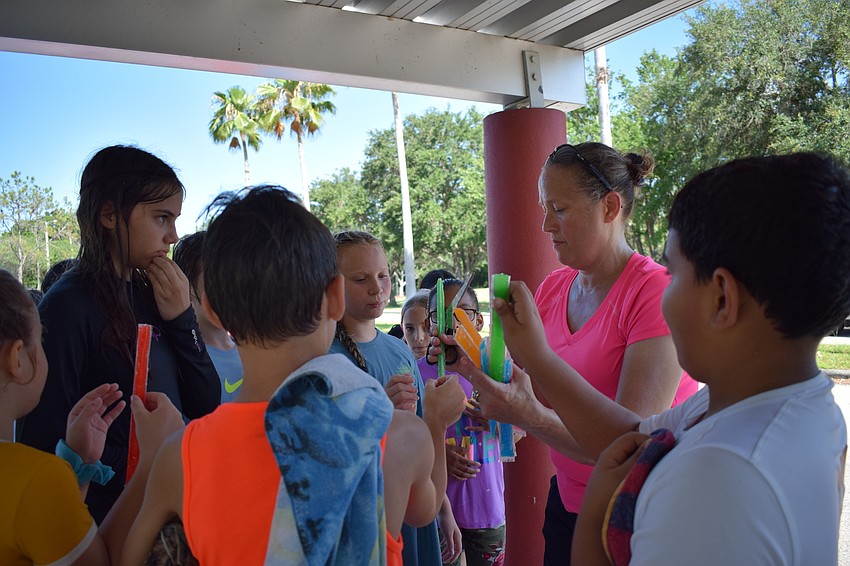Volunteer Dawn Illch couldn't distribute popsicles fast enough to students who were eager to cool down.