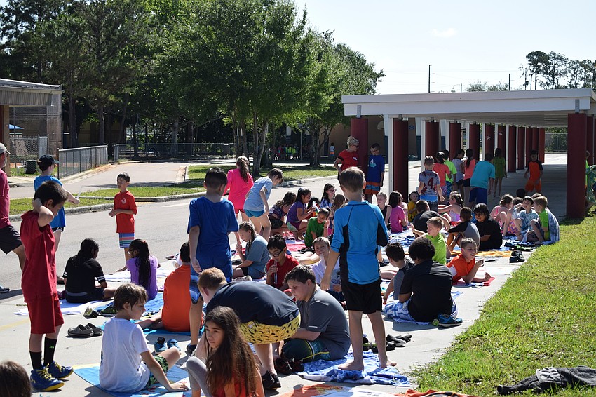 Some students spread out their towels and laid in the sun to try to expedite their drying process.