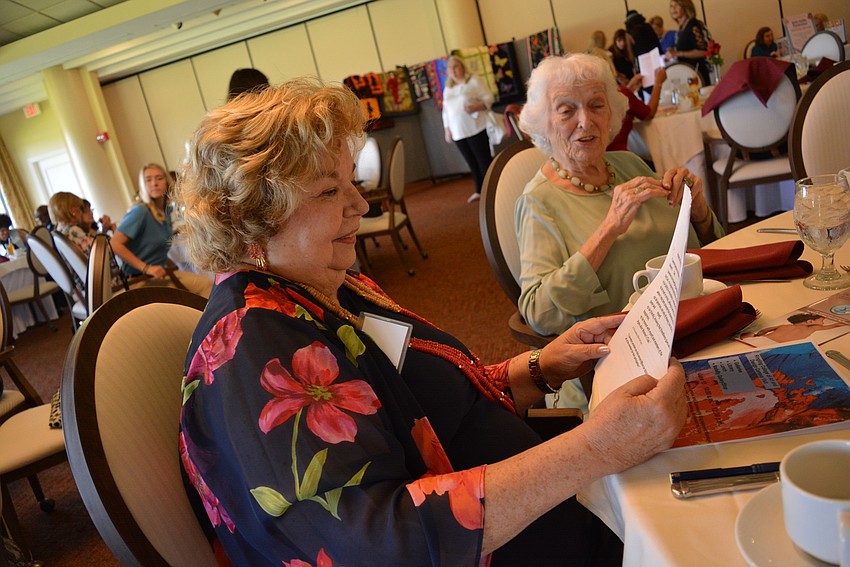 Past president Peg McKinley looks over the program just before the introduction of grant recipients.