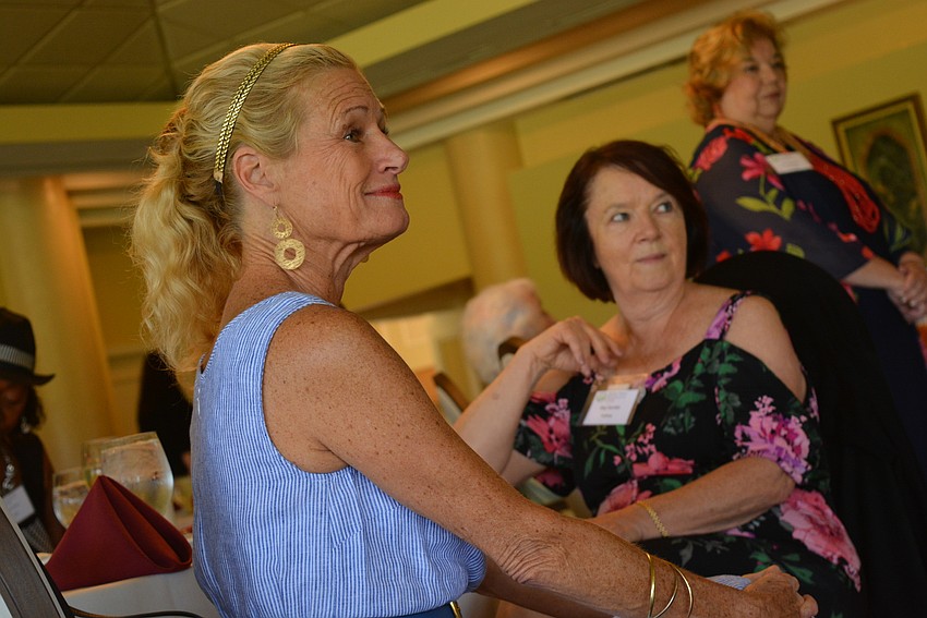 Member Kay Kwenski, with Meg Garofalo behind,  smiles as past presidents of the club are recognized for their years of service.