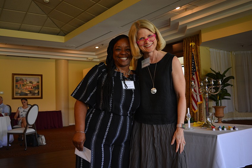 Alice Jones, of Brothers and Sisters Doing the Right Thing, accepts a grant from Patti Sue Peotter-Bettes.