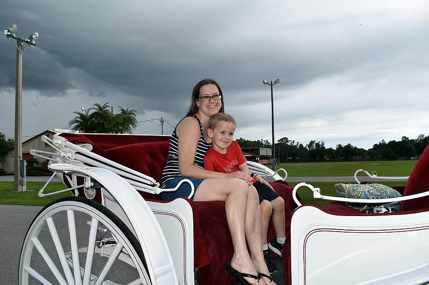Julie and Christopher Miller go for a ride in a horse-drawn carriage.