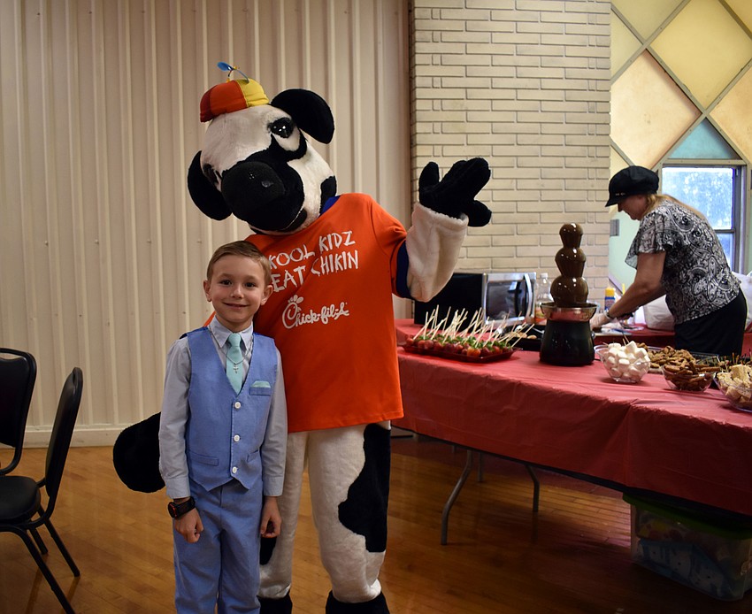 Nathan Gill smiles with a Chick-Fil-A cow.